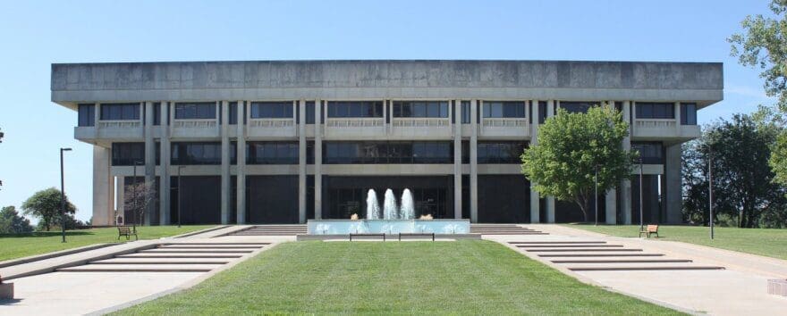 A photo of the Kansas Judicial Center. A large grey building in Topeka, Kansas. 