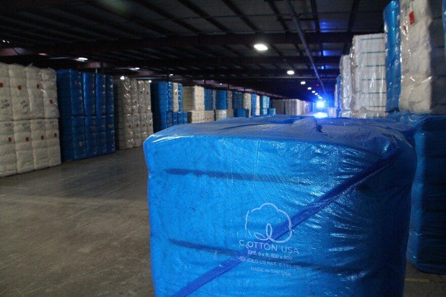 Cotton bales stacked up at a warehouse
